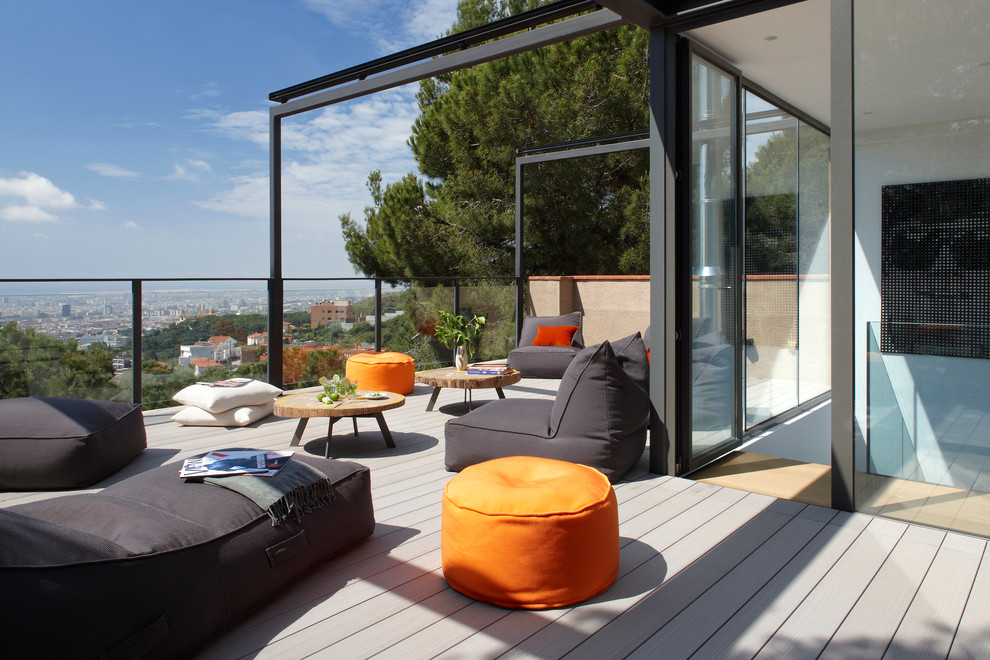 Design ideas for a mid-sized contemporary balcony in Barcelona with an awning.