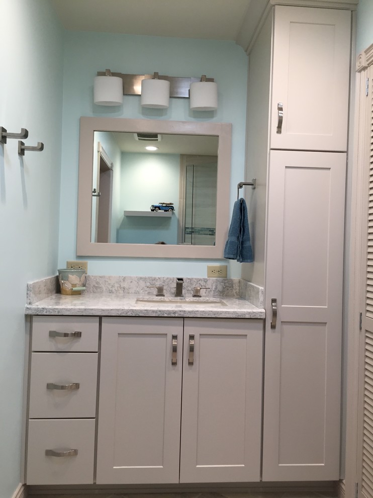 Mid-sized transitional gray tile and porcelain tile ceramic tile and gray floor walk-in shower photo in Phoenix with shaker cabinets, white cabinets, blue walls, an undermount sink, granite countertops and a hinged shower door