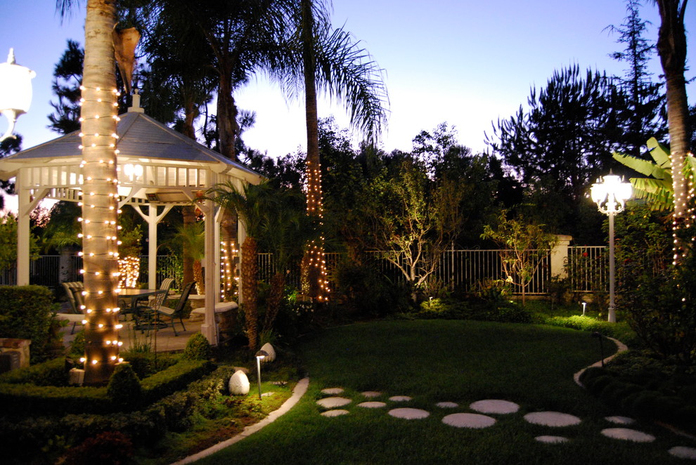 Inspiration for a huge transitional shade backyard brick landscaping in Orange County.