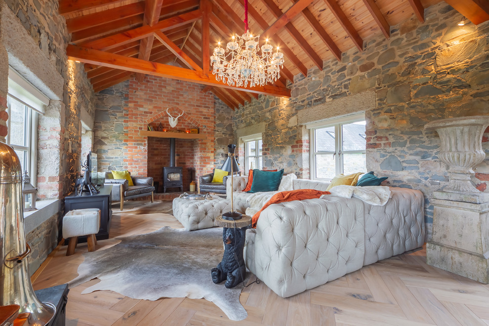 Inspiration for a country bedroom in Belfast with multi-coloured walls, light hardwood floors and a wood stove.