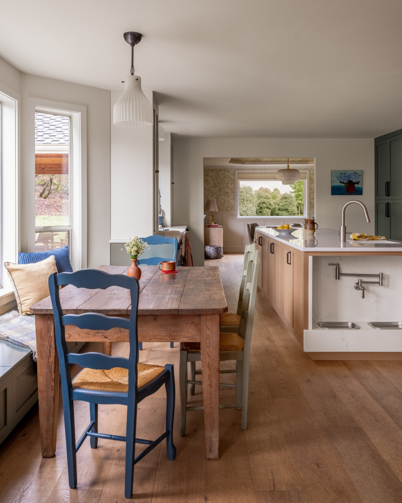 Example of a transitional medium tone wood floor and gray floor kitchen/dining room combo design in Seattle with white walls