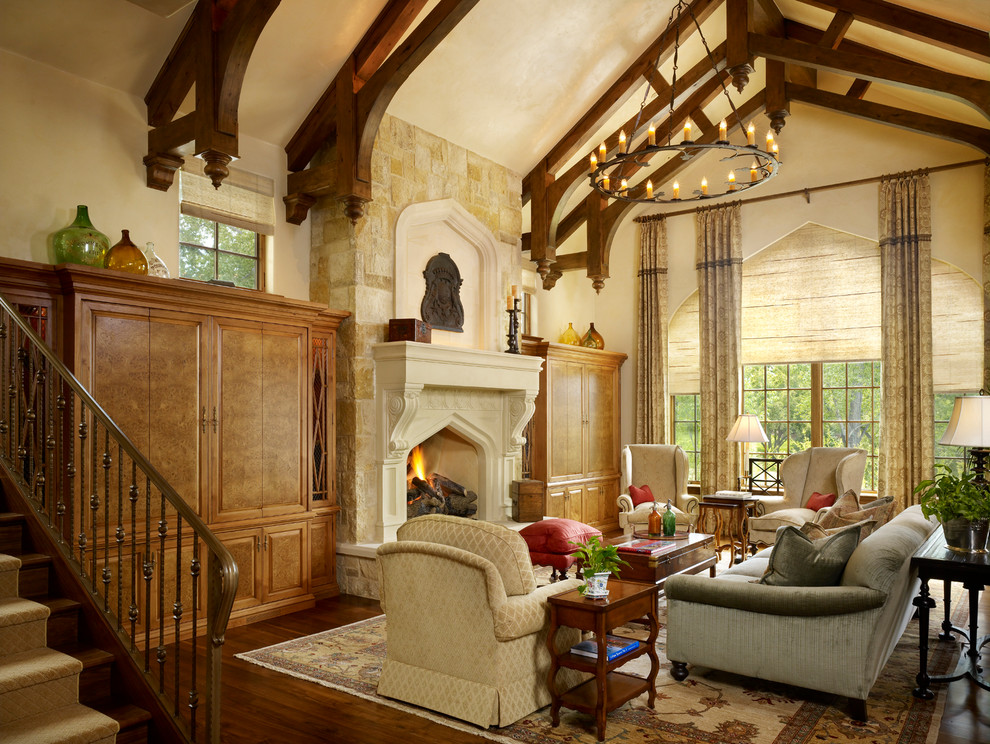 Photo of a traditional formal living room in Denver with beige walls, dark hardwood floors, a standard fireplace, a stone fireplace surround and no tv.