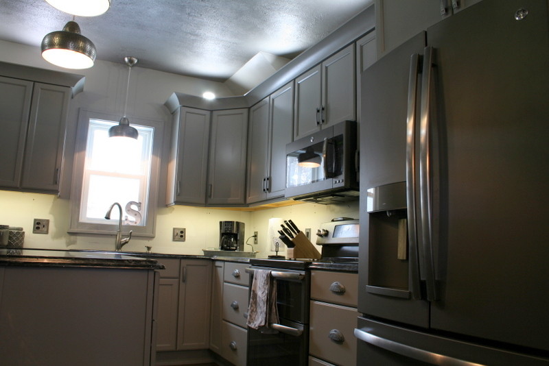 Inspiration for a small transitional l-shaped vinyl floor enclosed kitchen remodel with a double-bowl sink, flat-panel cabinets, gray cabinets, quartz countertops, stainless steel appliances and an island