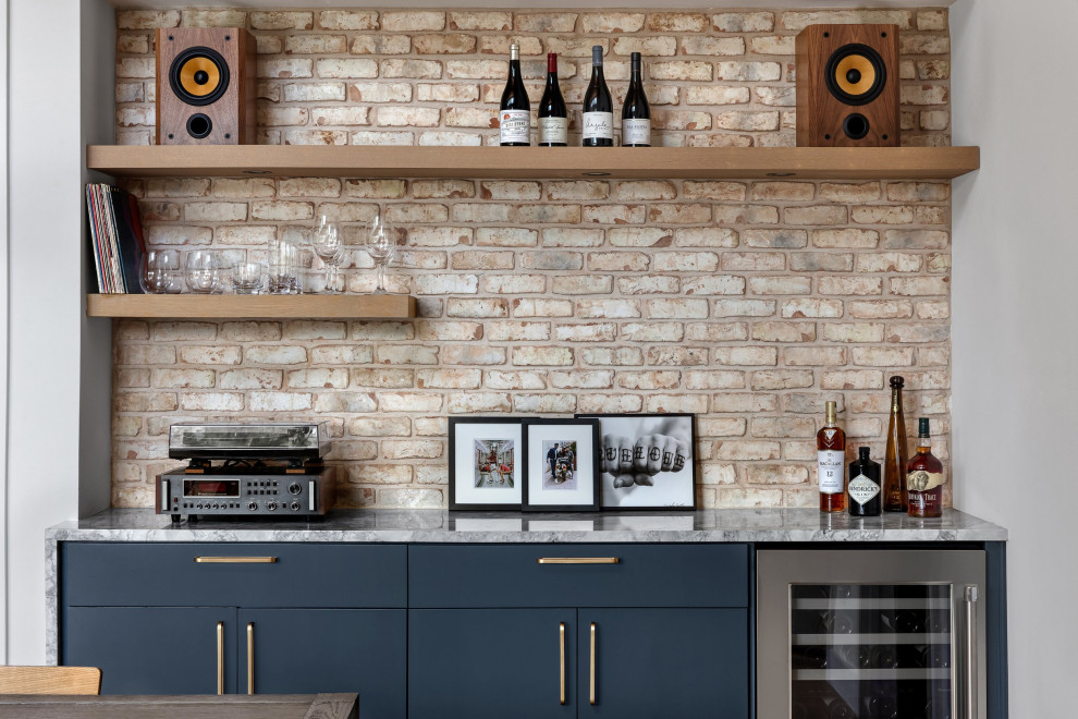 Small retro single-wall dry bar in Austin with flat-panel cabinets, blue cabinets, marble worktops, brick splashback, light hardwood flooring and grey worktops.