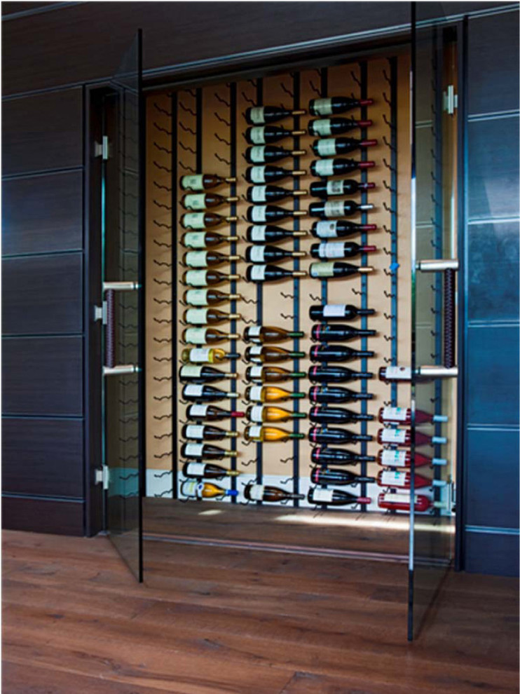 Inspiration for a large contemporary wine cellar in Denver with medium hardwood floors and display racks.