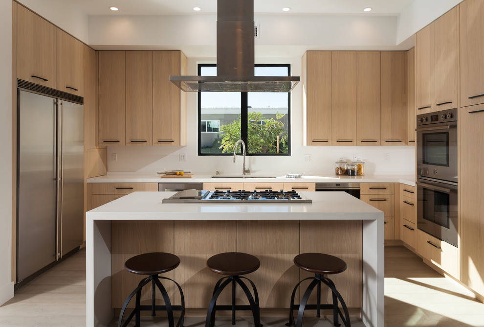 Design ideas for a contemporary l-shaped kitchen in Orange County with a double-bowl sink, flat-panel cabinets, light wood cabinets, stainless steel appliances, light hardwood floors and with island.