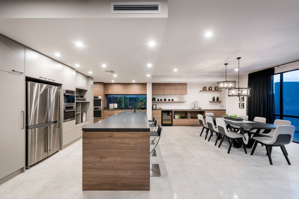 Contemporary l-shaped eat-in kitchen in Perth with an undermount sink, flat-panel cabinets, grey cabinets, stainless steel appliances, with island, grey floor and black benchtop.