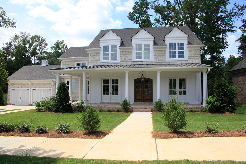 Inspiration for a mid-sized traditional two-storey beige exterior in Atlanta with mixed siding and a hip roof.
