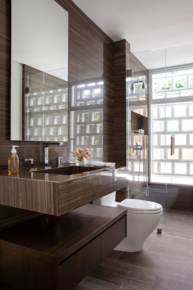 Design ideas for a contemporary bathroom in Orange County with flat-panel cabinets, dark wood cabinets, a curbless shower, a one-piece toilet, brown tile, an integrated sink, brown floor, a hinged shower door, brown benchtops, a niche, a single vanity and a floating vanity.