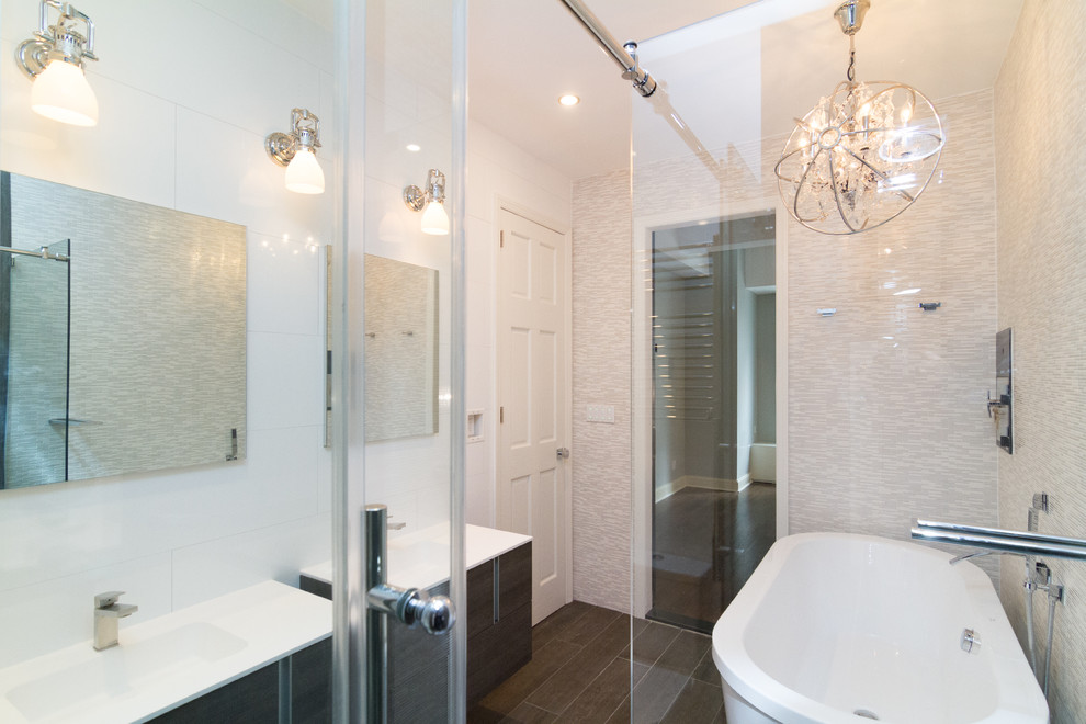 Mid-sized contemporary master bathroom in New York with dark wood cabinets, a freestanding tub, a corner shower, a one-piece toilet, white tile, white walls, an integrated sink, brown floor and a sliding shower screen.