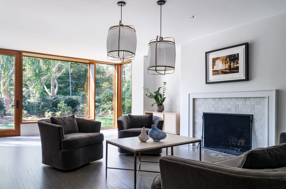 Large trendy open concept and formal gray floor and medium tone wood floor living room photo in New York with white walls, a standard fireplace, a tile fireplace and no tv