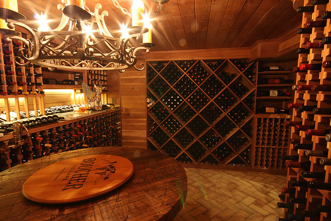 Wine cellar - rustic wine cellar idea in Denver with storage racks
