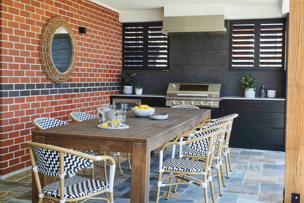 This is an example of a contemporary patio in Sydney with an outdoor kitchen and a roof extension.