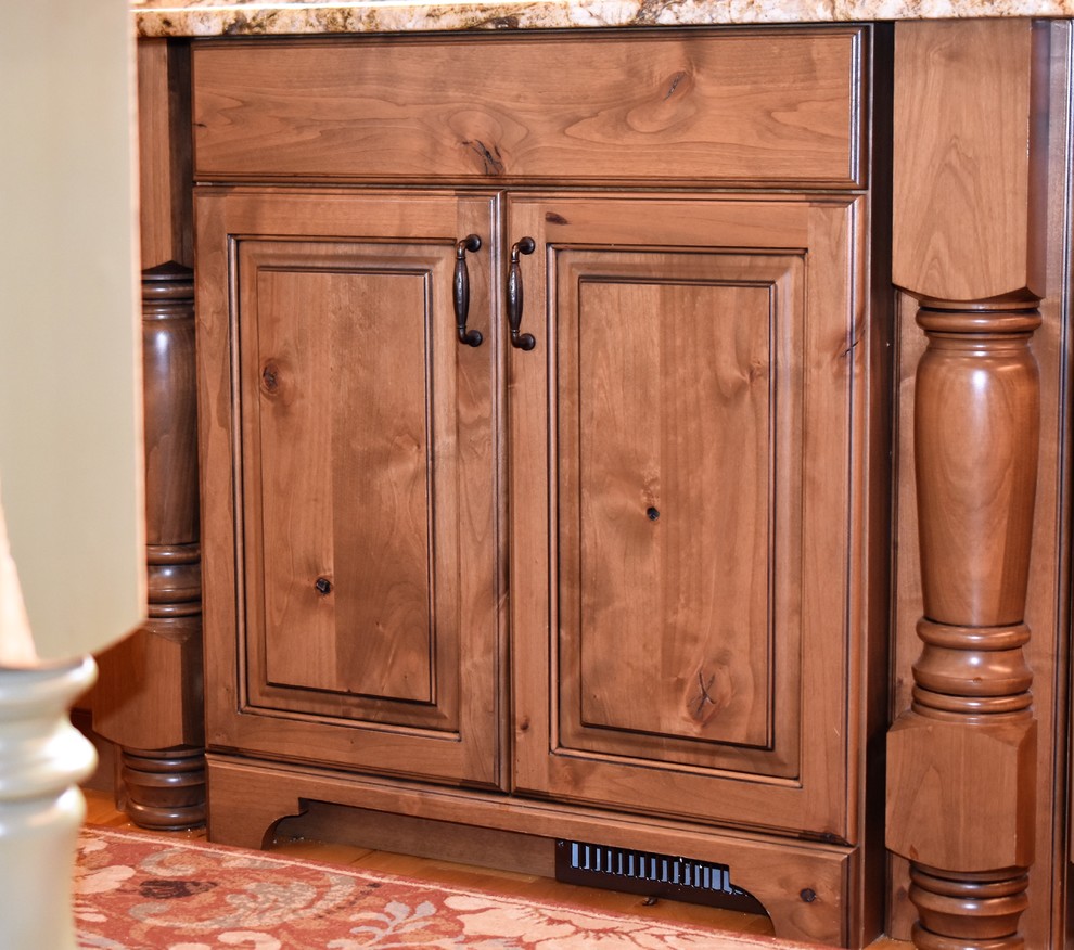 Example of a huge mountain style kitchen design with distressed cabinets
