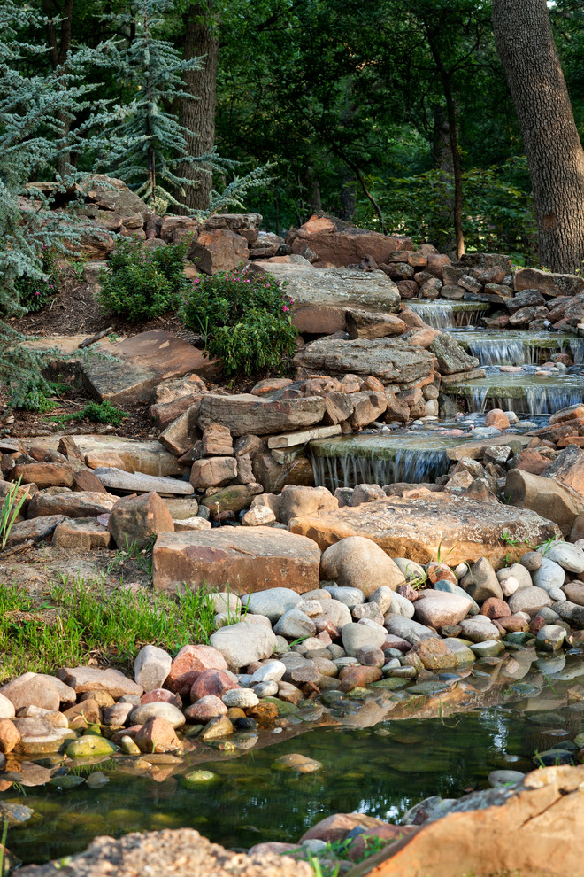 Photo of a traditional garden in Austin with a water feature.