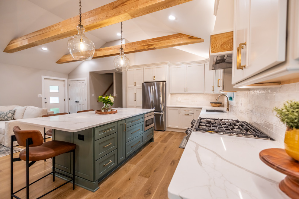 Eat-in kitchen - large transitional l-shaped light wood floor, brown floor and exposed beam eat-in kitchen idea in DC Metro with an undermount sink, shaker cabinets, quartz countertops, white backsplash, porcelain backsplash, stainless steel appliances, an island and white countertops