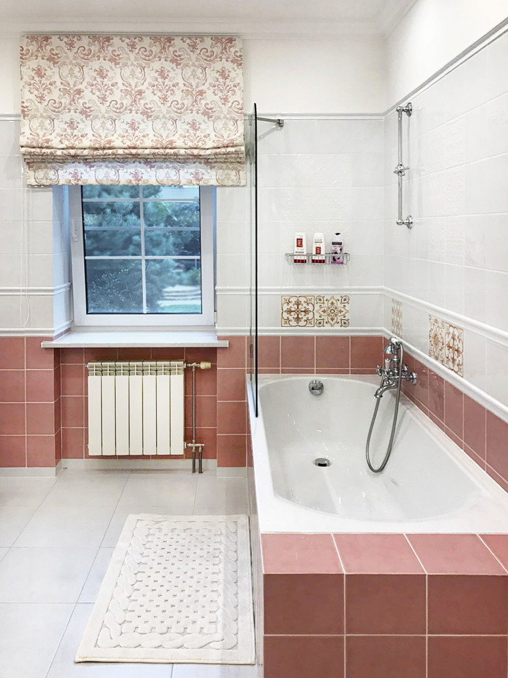 This is an example of a large classic ensuite bathroom in Moscow with beaded cabinets, white cabinets, a submerged bath, a wall mounted toilet, pink tiles, ceramic tiles, white walls, ceramic flooring, an integrated sink, white floors, a shower curtain, white worktops, an enclosed toilet, a single sink and a floating vanity unit.