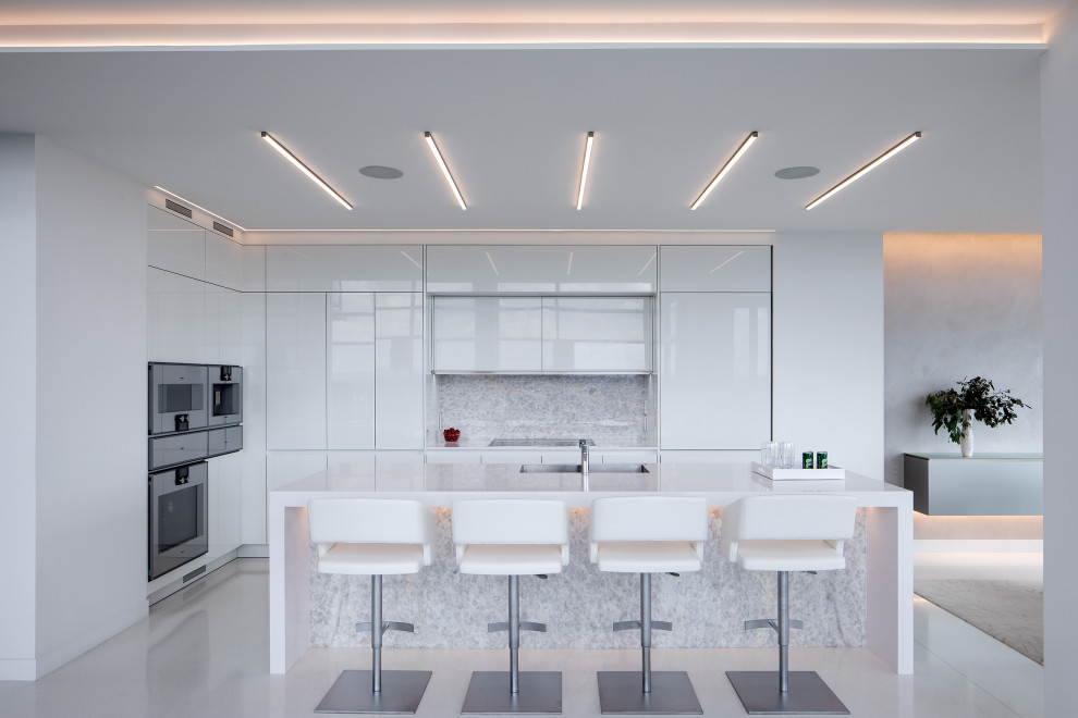 Design ideas for a modern kitchen in Philadelphia with flat-panel cabinets, white cabinets, quartz benchtops, white splashback, marble splashback, terrazzo floors, with island, yellow floor and white benchtop.