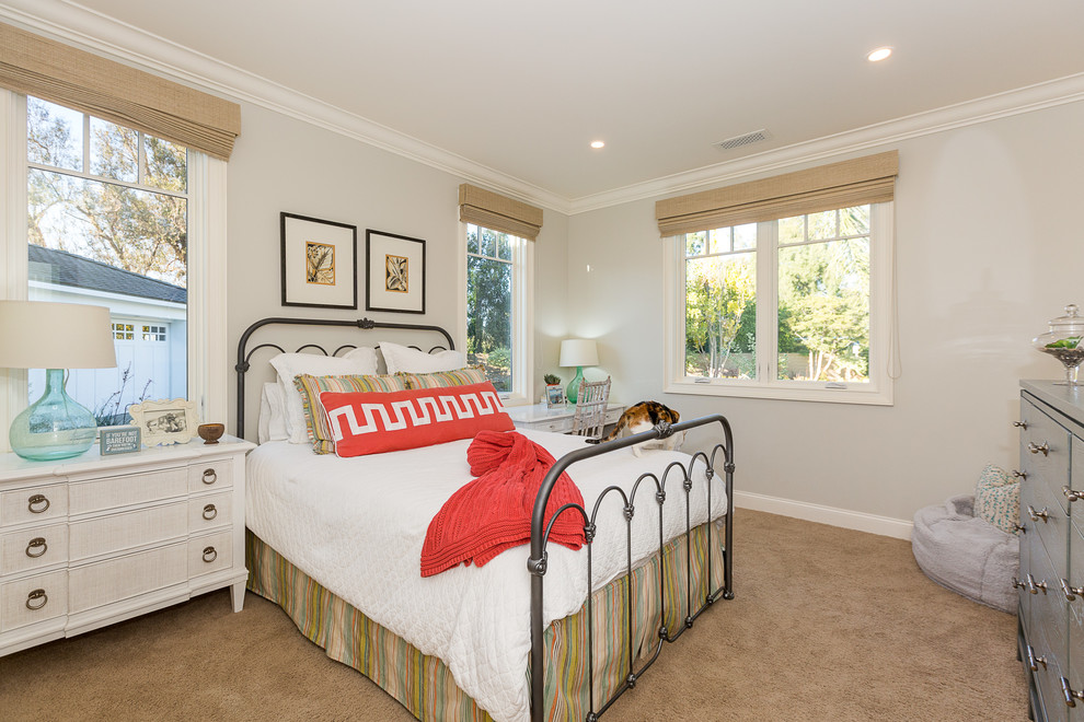 This is an example of a mid-sized transitional bedroom in Orange County with grey walls and carpet.