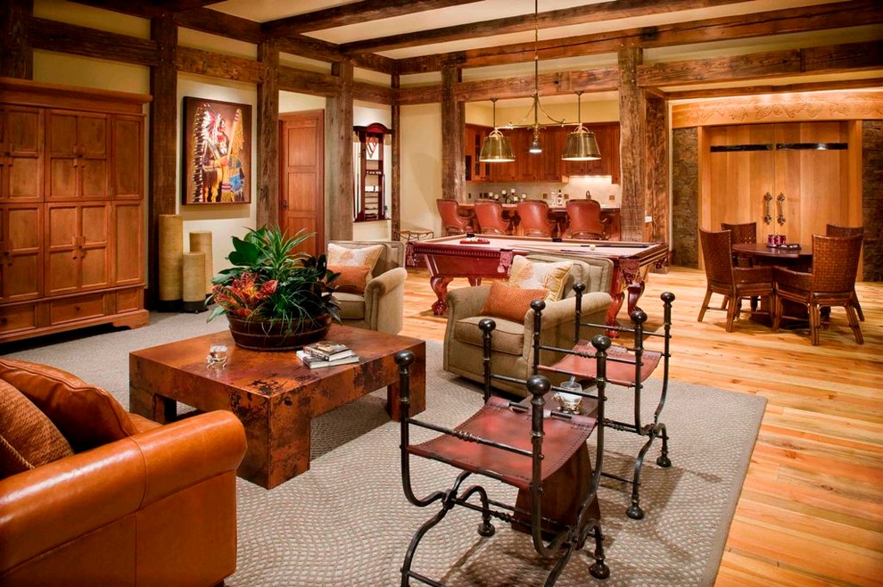 Photo of a country living room in Denver with a home bar, beige walls, light hardwood floors and a built-in media wall.