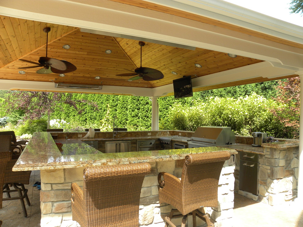 Design ideas for an expansive traditional backyard patio in Chicago with an outdoor kitchen and a gazebo/cabana.