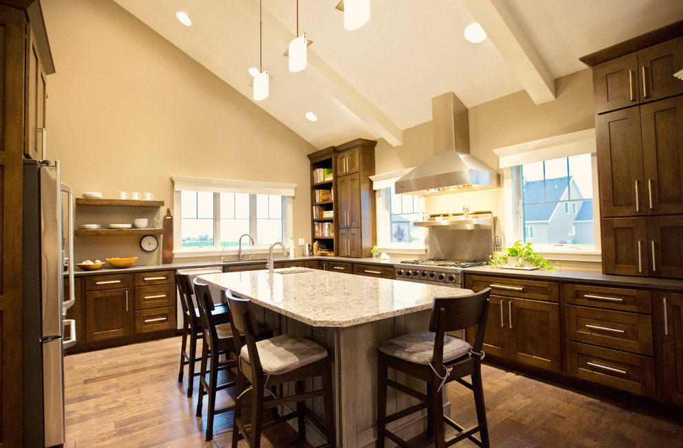 Example of a large transitional u-shaped vinyl floor and brown floor kitchen design in Chicago with an undermount sink, shaker cabinets, dark wood cabinets, granite countertops, stainless steel appliances, an island and gray countertops