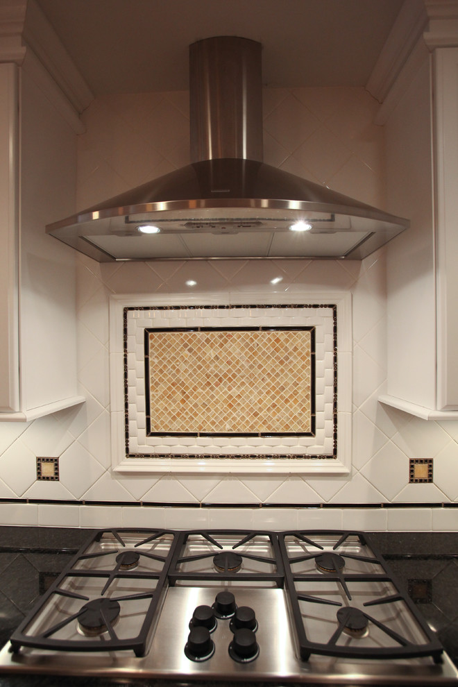 Inspiration for a mid-sized transitional l-shaped medium tone wood floor kitchen remodel with an undermount sink, raised-panel cabinets, white cabinets, quartz countertops, white backsplash, ceramic backsplash, stainless steel appliances and an island