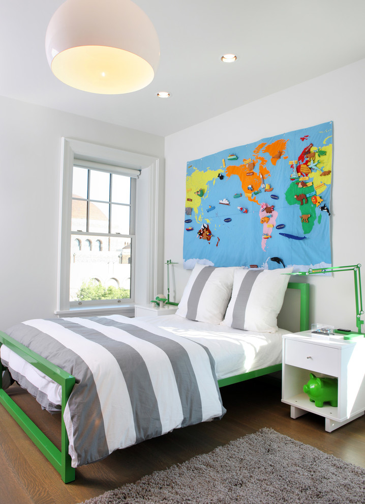 Photo of a contemporary gender-neutral kids' bedroom for kids 4-10 years old in Chicago with white walls, brown floor and medium hardwood floors.