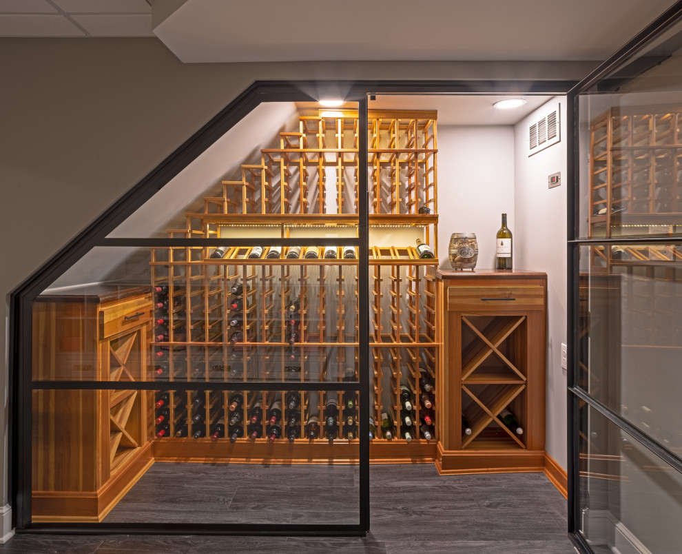 This is an example of a small contemporary wine cellar in Columbus with vinyl floors, storage racks and grey floor.