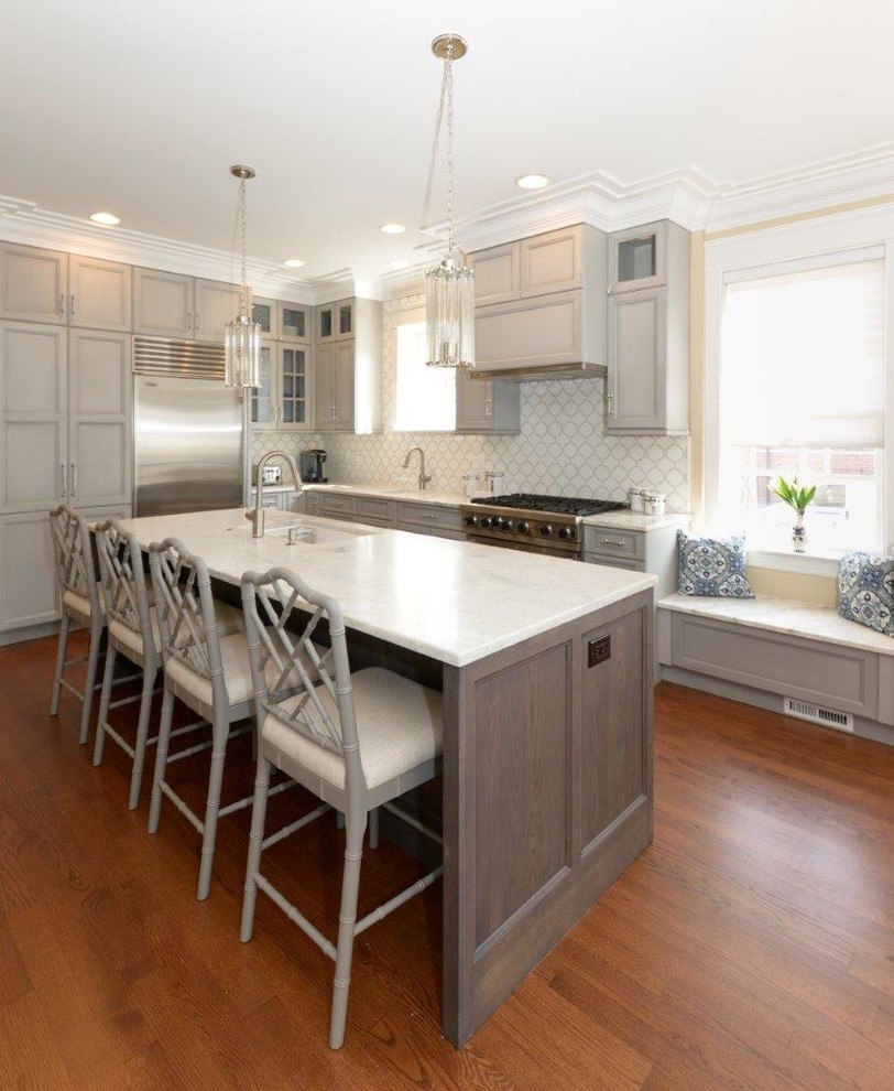 Example of a mid-sized transitional l-shaped medium tone wood floor eat-in kitchen design in Chicago with recessed-panel cabinets, gray cabinets, multicolored backsplash, an island, an undermount sink, quartzite countertops, mosaic tile backsplash and stainless steel appliances