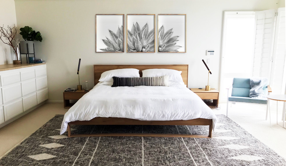 Example of a large beach style master carpeted and white floor bedroom design in San Diego with white walls