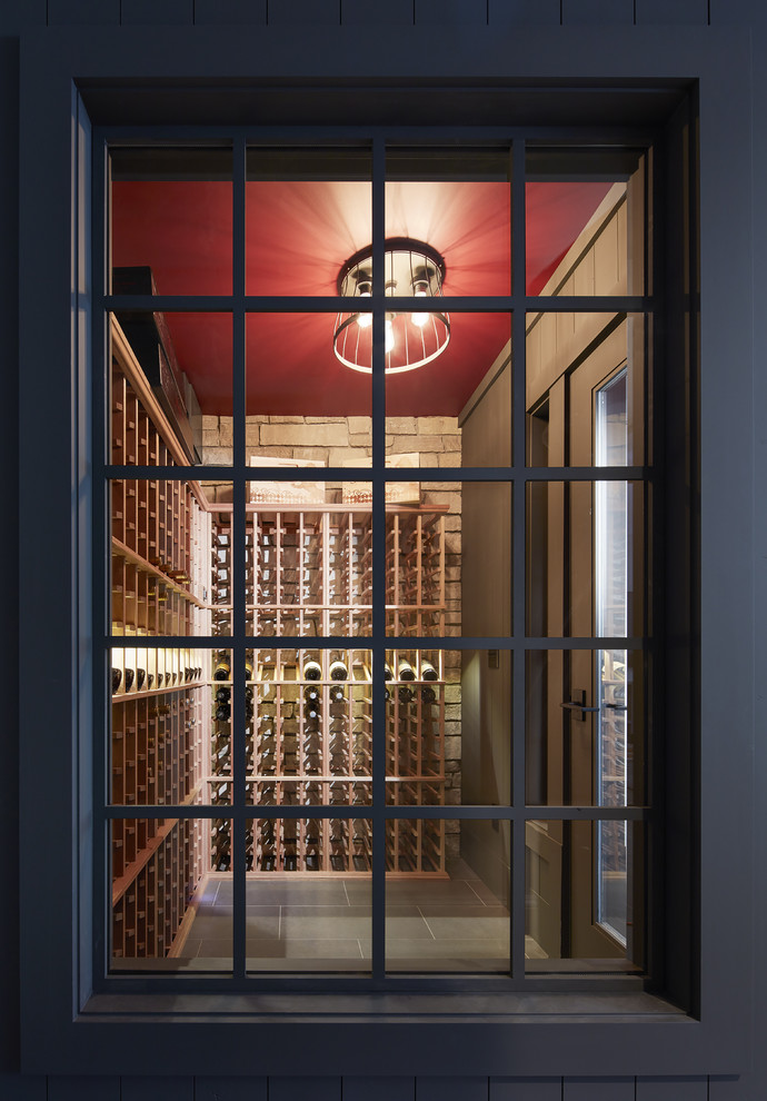 Mid-sized country wine cellar in Minneapolis with porcelain floors and storage racks.