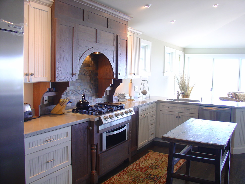 Photo of a mid-sized beach style single-wall eat-in kitchen in Boston with an undermount sink, recessed-panel cabinets, white cabinets, granite benchtops, brown splashback, ceramic splashback, stainless steel appliances and dark hardwood floors.