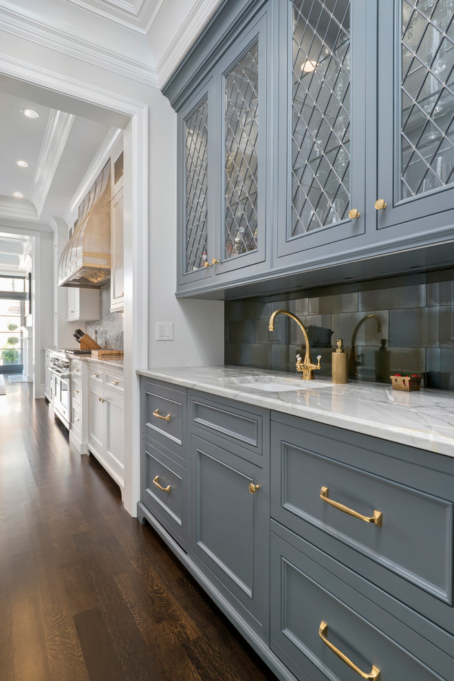 Open concept kitchen - huge transitional galley dark wood floor open concept kitchen idea in Chicago with an undermount sink, recessed-panel cabinets, gray cabinets, quartzite countertops, gray backsplash, glass tile backsplash and paneled appliances