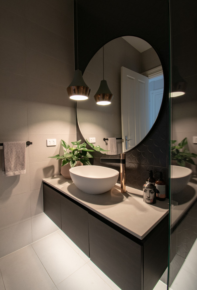 This is an example of a classic cloakroom in Melbourne with beaded cabinets, black cabinets, black tiles, porcelain tiles, porcelain flooring, engineered stone worktops, grey floors, grey worktops and a floating vanity unit.