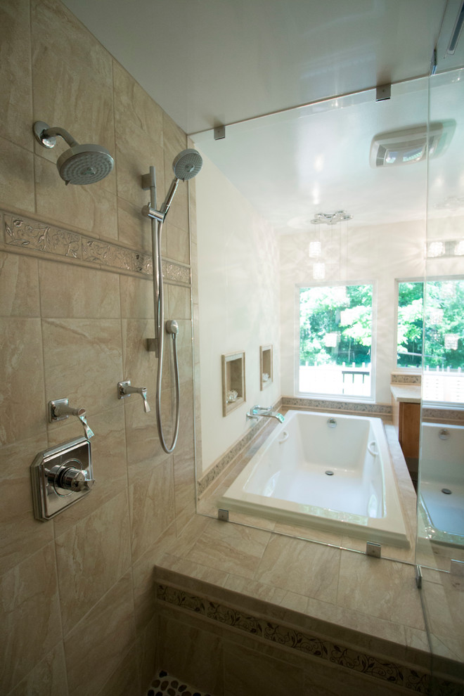 Inspiration for a mid-sized transitional master beige tile and ceramic tile ceramic tile drop-in bathtub remodel with an undermount sink, flat-panel cabinets, light wood cabinets, solid surface countertops, a two-piece toilet and beige walls