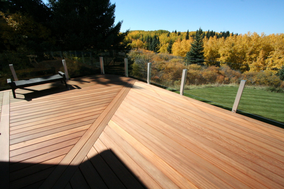 Deck - mid-sized transitional backyard deck idea in Calgary with no cover