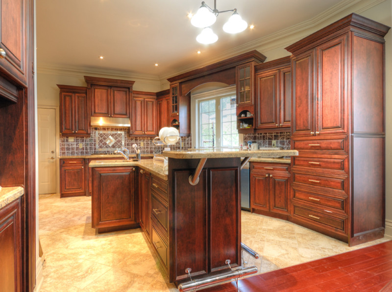 Example of a marble floor kitchen design in Toronto with dark wood cabinets, granite countertops, beige backsplash, stainless steel appliances and an island