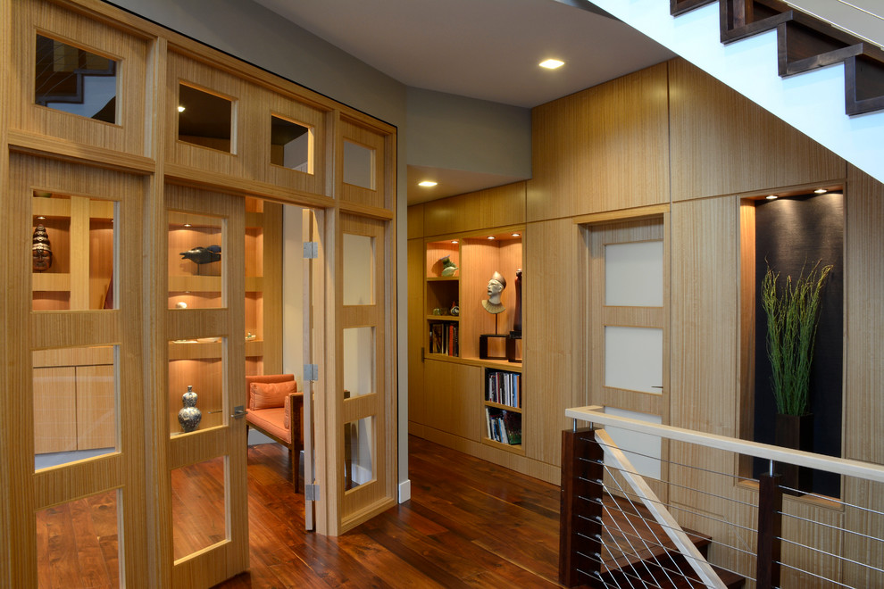 Large minimalist dark wood floor and brown floor hallway photo in Philadelphia with gray walls