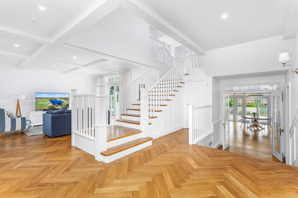 Design ideas for a beach style wood l-shaped staircase in Wollongong with painted wood risers and wood railing.