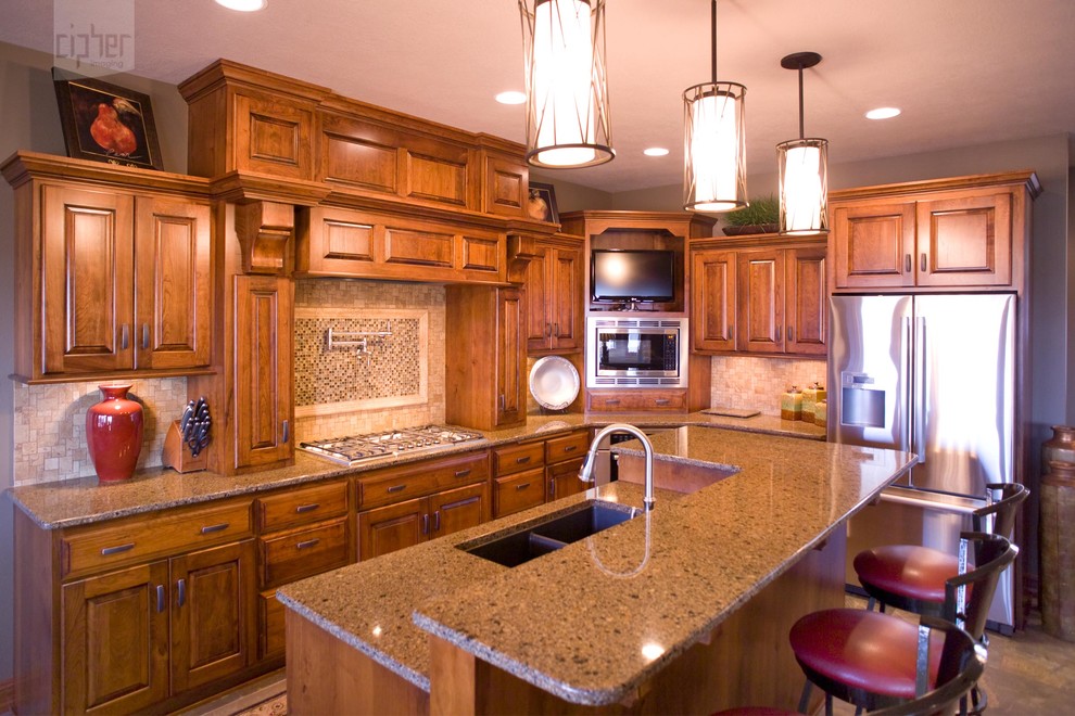 Example of a mid-sized transitional l-shaped light wood floor and brown floor eat-in kitchen design with an undermount sink, raised-panel cabinets, multicolored backsplash, stainless steel appliances, beige walls, an island, medium tone wood cabinets, granite countertops and ceramic backsplash