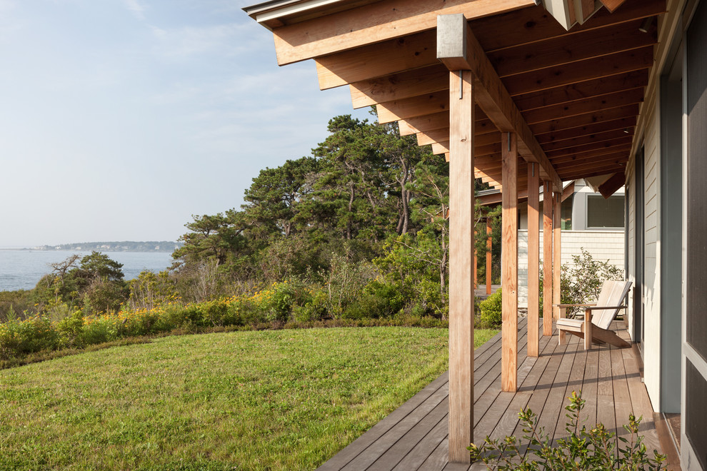 Design ideas for a mid-sized contemporary backyard verandah in Portland Maine with decking and a roof extension.