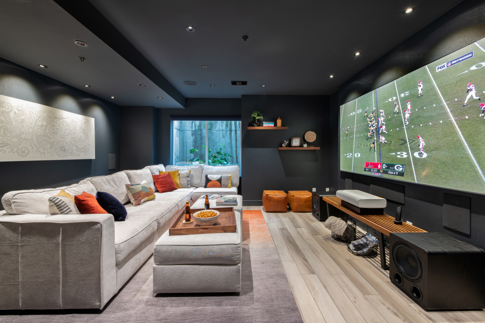 Inspiration for a contemporary home theatre in Denver with black walls and a projector screen.