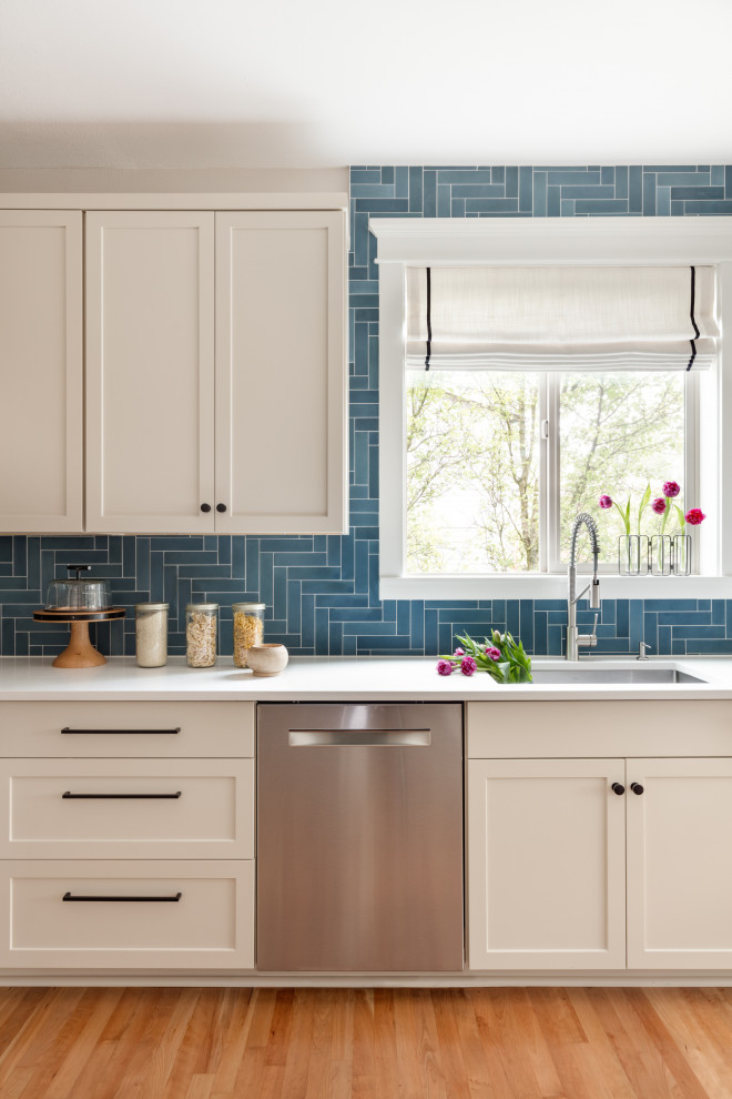 Inspiration for a medium sized traditional kitchen in Seattle with a submerged sink, shaker cabinets, engineered stone countertops, blue splashback, cement tile splashback, stainless steel appliances and white worktops.