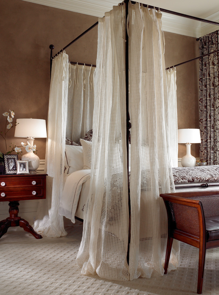 Inspiration for a traditional bedroom in Miami with beige walls and carpet.