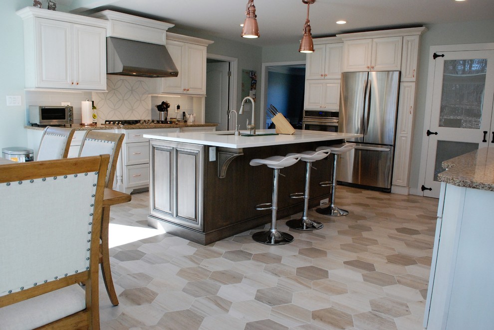 Enclosed kitchen - mid-sized transitional l-shaped porcelain tile and beige floor enclosed kitchen idea in New York with an undermount sink, raised-panel cabinets, white cabinets, solid surface countertops, white backsplash, porcelain backsplash, stainless steel appliances and an island