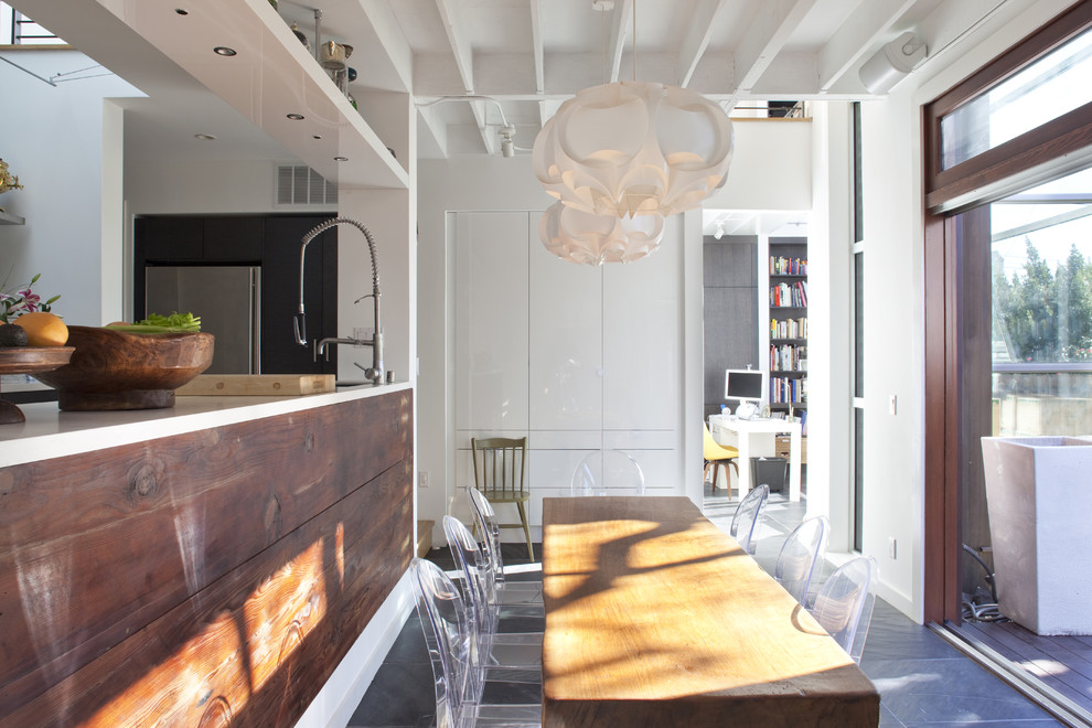 This is an example of a contemporary kitchen/dining combo in San Francisco with white walls.