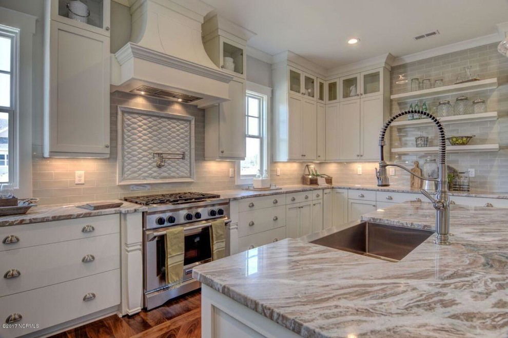 Inspiration for a huge transitional u-shaped medium tone wood floor and brown floor kitchen pantry remodel with a farmhouse sink, shaker cabinets, white cabinets, quartz countertops, beige backsplash, ceramic backsplash, stainless steel appliances and an island