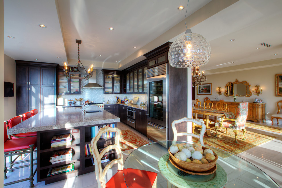 Enclosed kitchen - mid-sized transitional l-shaped porcelain tile enclosed kitchen idea in Indianapolis with an undermount sink, shaker cabinets, dark wood cabinets, quartz countertops, white backsplash, glass tile backsplash, stainless steel appliances and an island