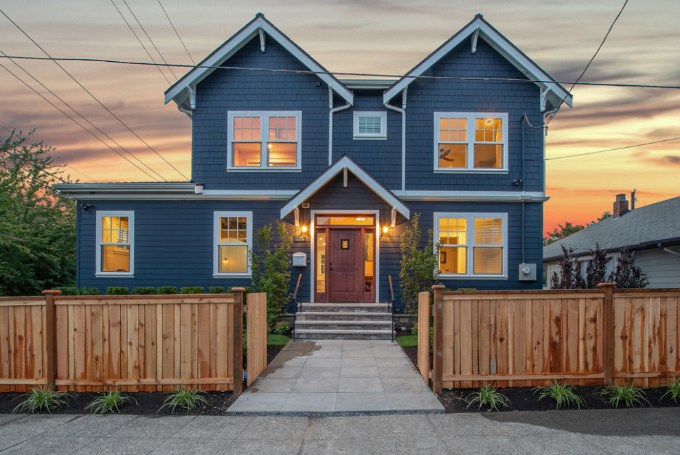 Photo of a large arts and crafts blue house exterior in Seattle with four or more storeys, concrete fiberboard siding, a gable roof and a shingle roof.
